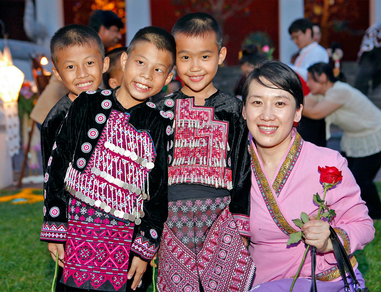 Happy lady welcomed with a rose by orphans from Bandekdee Orphanage during a fundraising Gala event